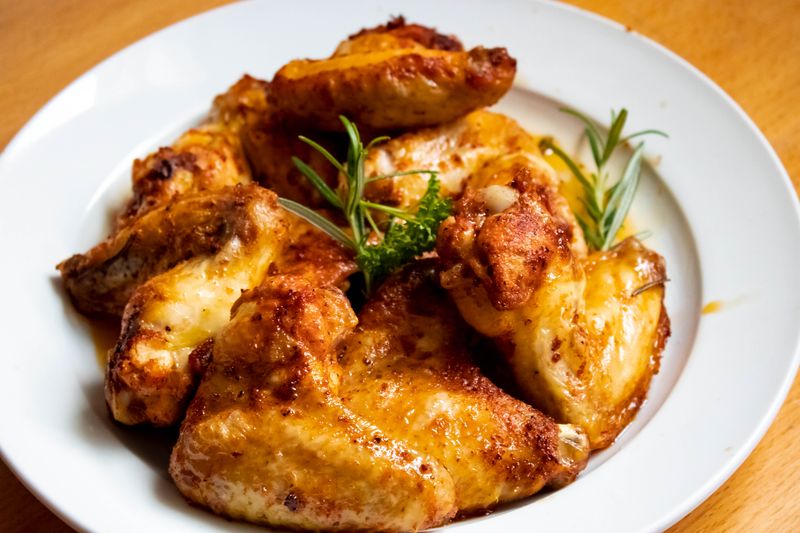 Sriracha Honey Blaze Wings — sweet and spicy wings over dish
